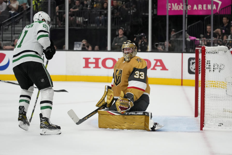 Dallas Stars left wing Jason Robertson (21) scores against Vegas Golden Knights goaltender Adin Hill (33) during the first period of Game 1 of the NHL hockey Stanley Cup Western Conference finals Friday, May 19, 2023, in Las Vegas. (AP Photo/John Locher)