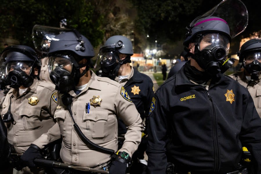 US Police officers stand guard near a pro-Palestinian encampment set up on the campus of the University of California Los Angeles (UCLA), after clashes erupted in Los Angeles on May 1, 2024. Clashes broke out on May 1, 2024 around pro-Palestinian demonstrations at the University of California, Los Angeles, as universities around the United States struggle to contain similar protests on dozens of campuses. (Photo by ETIENNE LAURENT / AFP) (Photo by ETIENNE LAURENT/AFP via Getty Images)