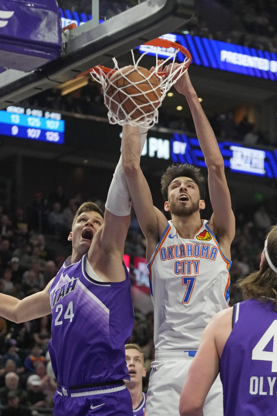 Oklahoma City Thunder forward Chet Holmgren (7) scores against Utah Jazz center Walker Kessler (24) during the first half of an NBA basketball game Tuesday, Feb. 6, 2024, in Salt Lake City. (AP Photo/Rick Bowmer)