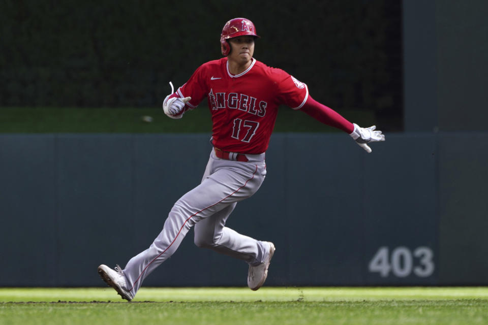 Los Angeles Angels' Shohei Ohtani watches as he advances to second base on a Minnesota Twins error after his single off Twins pitcher Dylan Bundy in the first inning of a baseball game, Sunday, Sept 25, 2022, in Minneapolis. (AP Photo/Jim Mone)