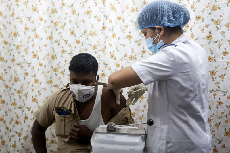 A policeman receives a dose of COVISHIELD, a COVID-19 vaccine manufactured by Serum Institute of India, at a vaccination centre, in Mumbai