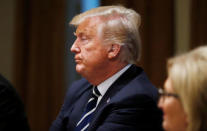 U.S. President Donald Trump ignores shouted questions from repoters as they are ushered out of the room as Rep. Diane Black (R-TN) looks on after the president spoke about his summit meeting in Finland with Russian President Vladimir Putin at the start of a meeting with members of the U.S. Congress at the White House in Washington, July 17, 2018. REUTERS/Leah Millis