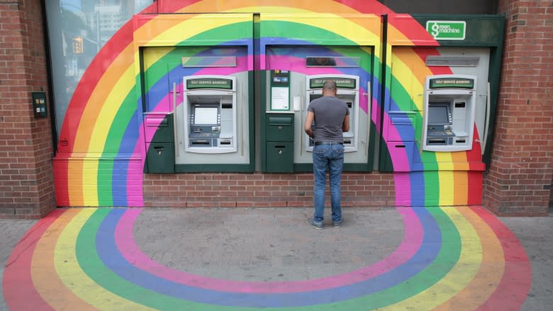 A gay pride rainbow surrounds a bank ATM in Toronto's Church and Wellesley gay village district.