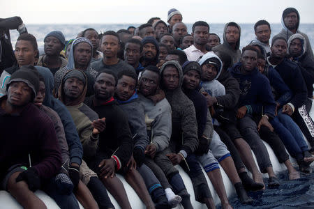 Sub-Saharan migrants are seen aboard an overcrowded raft during a rescue operation. REUTERS/Giorgos Moutafis