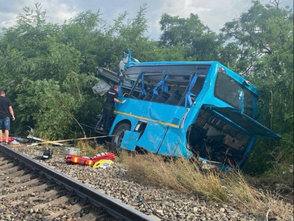 The destroyed bus after it collided with a passenger train in Slovakia (AFP)