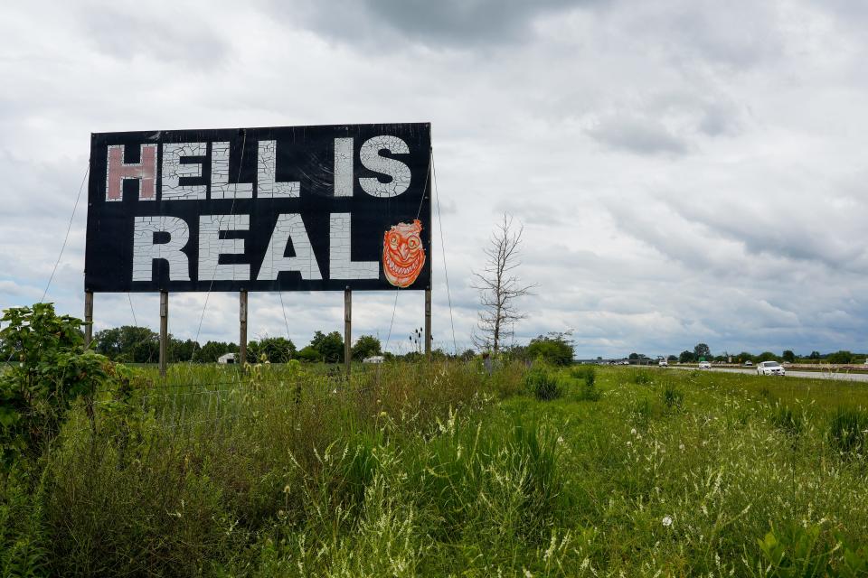 The Hell is Real sign is on Interstate 71 between Cincinnati and Columbus, Ohio was put up in 2004. A vandal earlier this year painted a devil smile on one side of the sign.