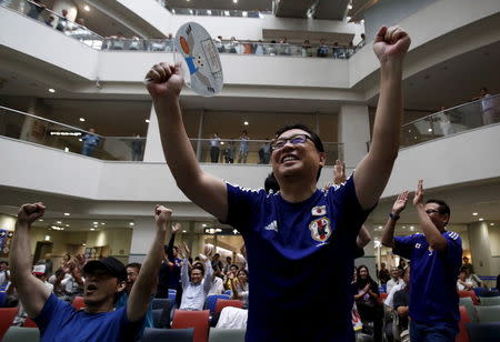 Japan's soccer fans celebrate their victory over England at FIFA Women's World Cup semi-final soccer match, at a public viewing event in Tokyo, Japan, July 2, 2015. REUTERS/Yuya Shino