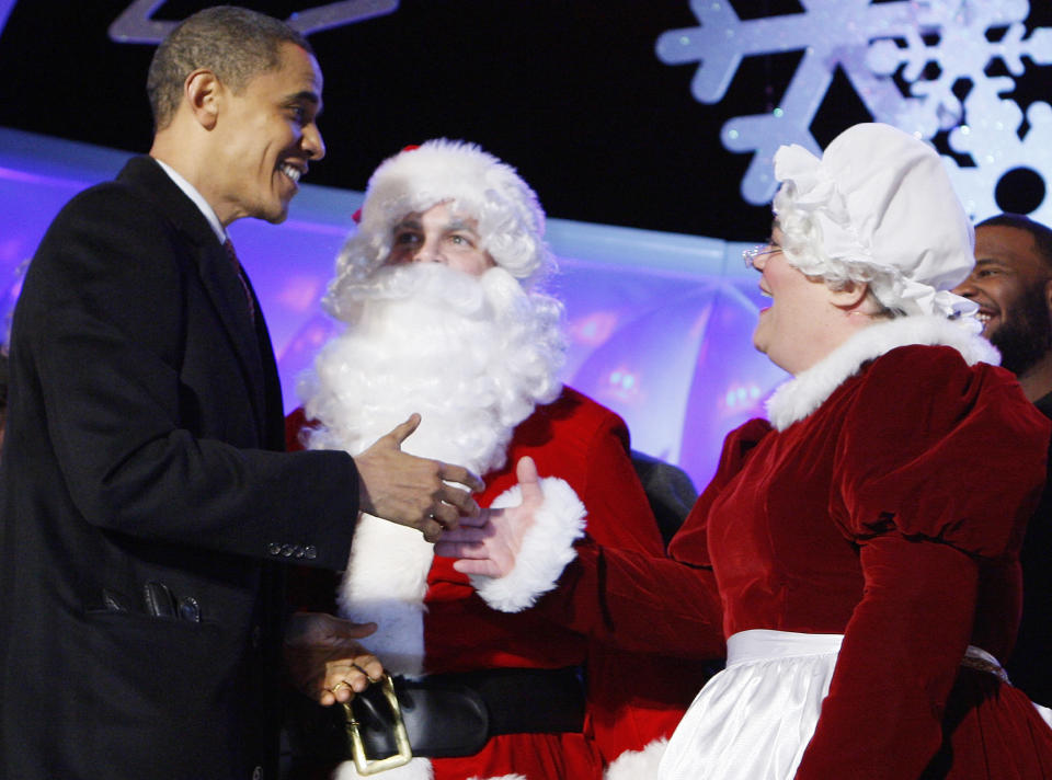 President Barack Obama greets Santa Claus and Mrs. Claus, played by Brad and Victoria Oscar, as they participate in the National Christmas Tree Lighting Ceremony in Washington, Thursday, Dec. 3, 2009. (AP Photo/Charles Dharapak)