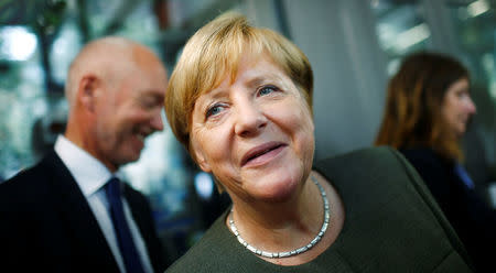 FILE PHOTO - German Chancellor Angela Merkel, top candidate of the Christian Democratic Union Party (CDU), visits shops after presenting a new interactive election campaign ahead of the upcoming federal election in Berlin, Germany August 18, 2017. REUTERS/Hannibal Hanschke