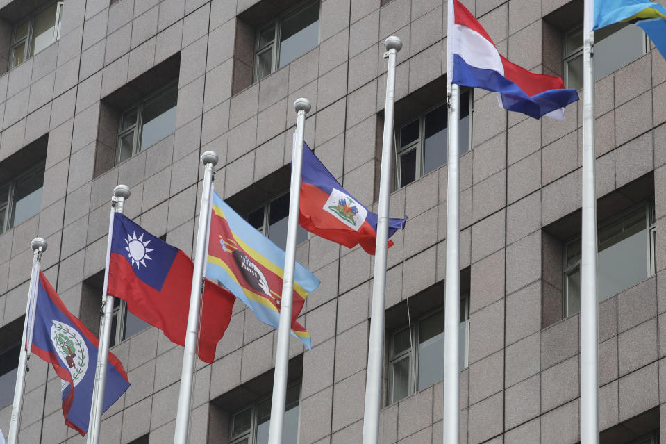 A pole, third from right, where Nauru national flag used to fly is vacant outside the Diplomatic Quarter building in Taipei, Taiwan, Monday, Jan. 15, 2024. The Pacific Island nation of Nauru says it is switching diplomatic recognition from Taiwan to China. The move on Monday leaves Taiwan with 12 diplomatic allies around the world. Taiwan now has official ties with 11 countries and the Vatican. (AP Photo/Chiang Ying-ying)