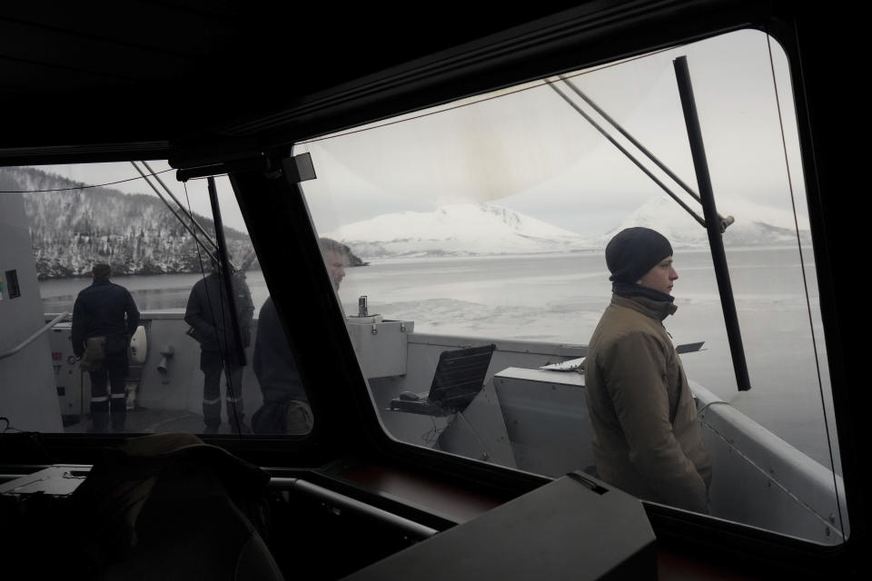 French sailors watch the docking manoeuvre of the French navy frigate Normandie for a port call in a Norwegian fjord, north of the Arctic circle, Friday March 8, 2024. The French frigate is part of a NATO force conducting exercises in the seas, north of Norway, codenamed Steadfast Defender, which are the largest conducted by the 31 nation military alliance since the cold war. (AP Photo/Thibault Camus)