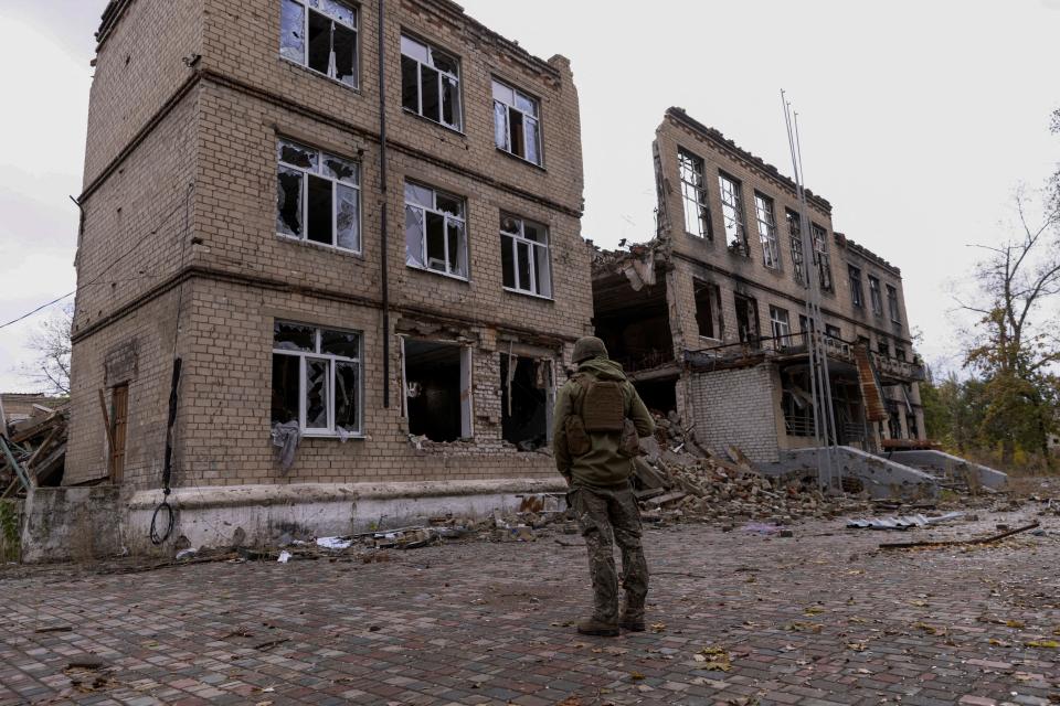 A police officer stands in front of a damaged building, amid Russia's attack on Ukraine, in the town of Avdiivka, Donetsk region, this week (REUTERS)