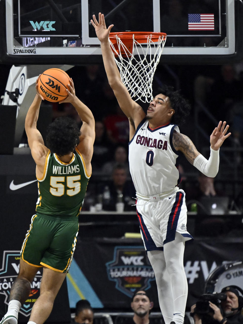 San Francisco guard Marcus Williams (55) shoots against Gonzaga guard Julian Strawther (0) during the second half of an NCAA college basketball game in the semifinals of the West Coast Conference men's tournament Monday, March 6, 2023, in Las Vegas. (AP Photo/David Becker)