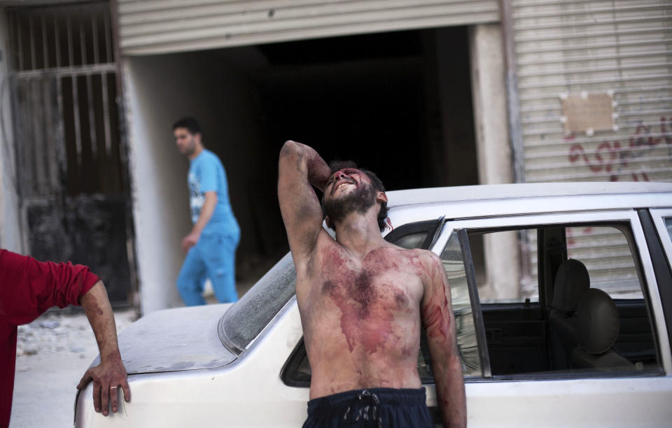 FILE - In this Thursday, Oct. 4, 2012 file photo, a Syrian man cries outside the Dar El Shifa hospital in Aleppo, Syria after his daughter was injured during a Syrian Air Force strike over a school where hundreds of refugees had taken shelter. Syria’s uprising was not destined to be quick. Instead, the largely peaceful protest movement that spread across the nation slowly turned into an armed insurgency and eventually a full-blown civil war. More than 130,000 people have been killed, and more than 2 million more have fled the country. Nearly three years after the crisis began, Syria's government and opposition are set to meet in Geneva this week for the first direct talks aimed at ending the conflict. (AP Photo/ Manu Brabo, File)