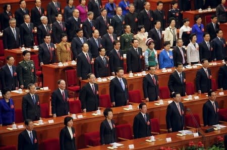 President Xi Jinping (2nd row, 5th L), Premier Li Keqiang (2nd row, 6th L) and other Chinese leaders sing China's national anthem during the closing ceremony of National People's Congress (NPC) at the Great Hall of the People in Beijing, China, March 16, 2016. REUTERS/Damir Sagolj