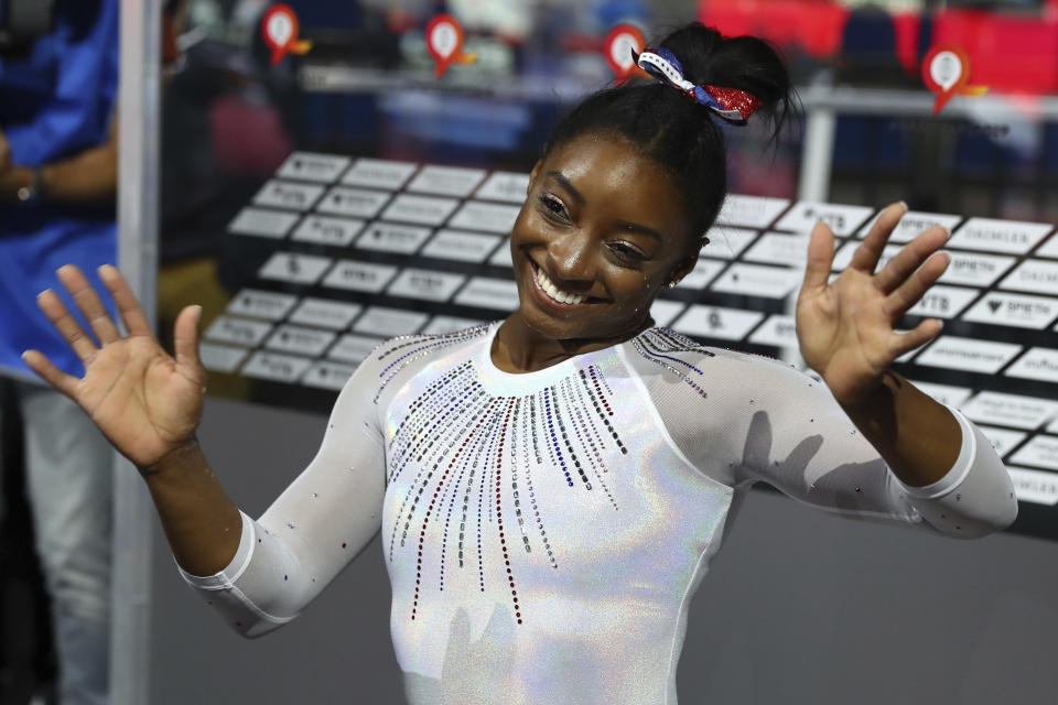 Gold medal winner Simone Biles of the U.S. celebrates after the women's all-around final at the Gymnastics World Championships in Stuttgart, Germany, Thursday, Oct. 10, 2019. (AP Photo/Matthias Schrader)