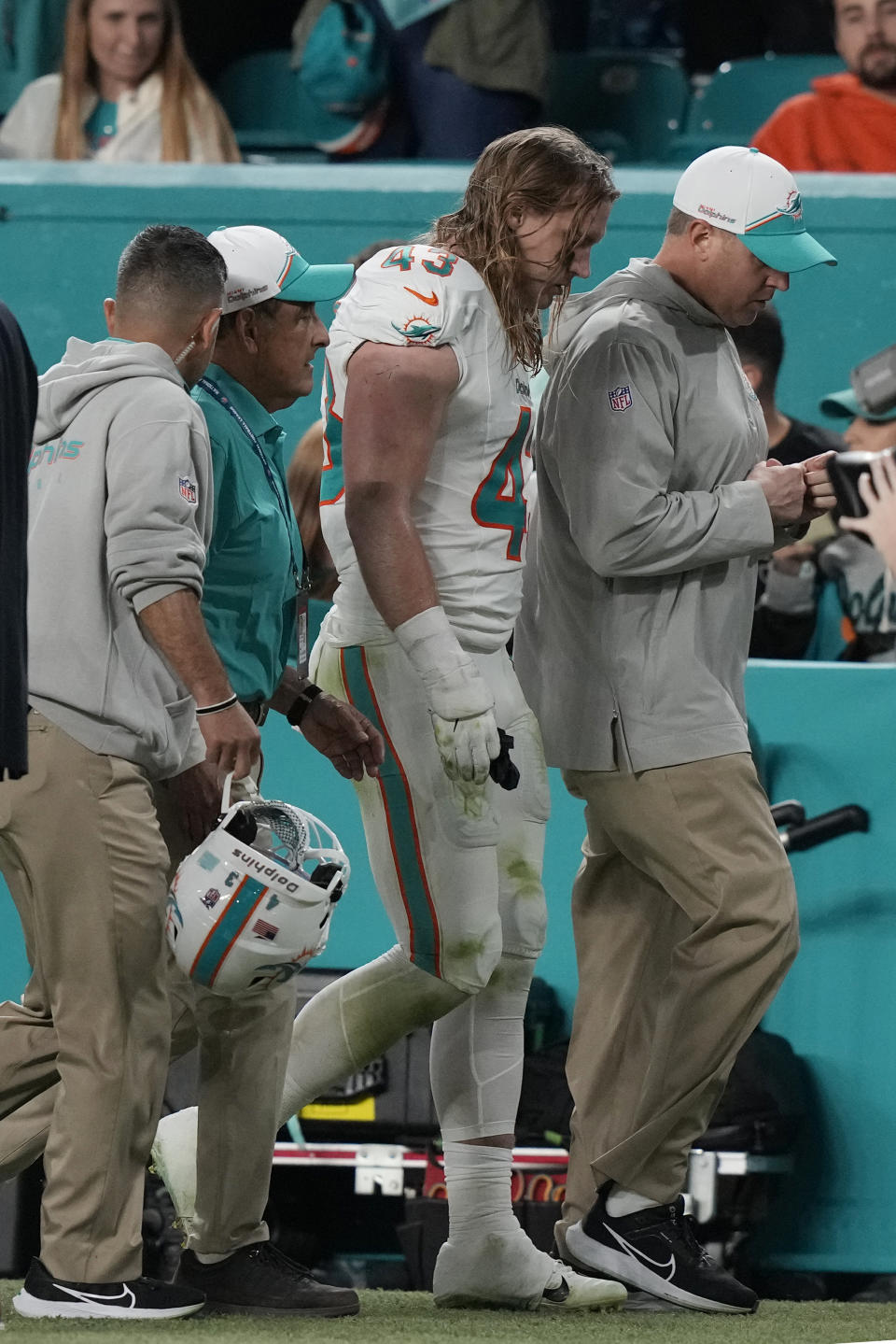 Miami Dolphins linebacker Andrew Van Ginkel (43) is escorted off the field during the second half of an NFL football game Buffalo Bills, Sunday, Jan. 7, 2024, in Miami Gardens, Fla. (AP Photo/Lynne Sladky)