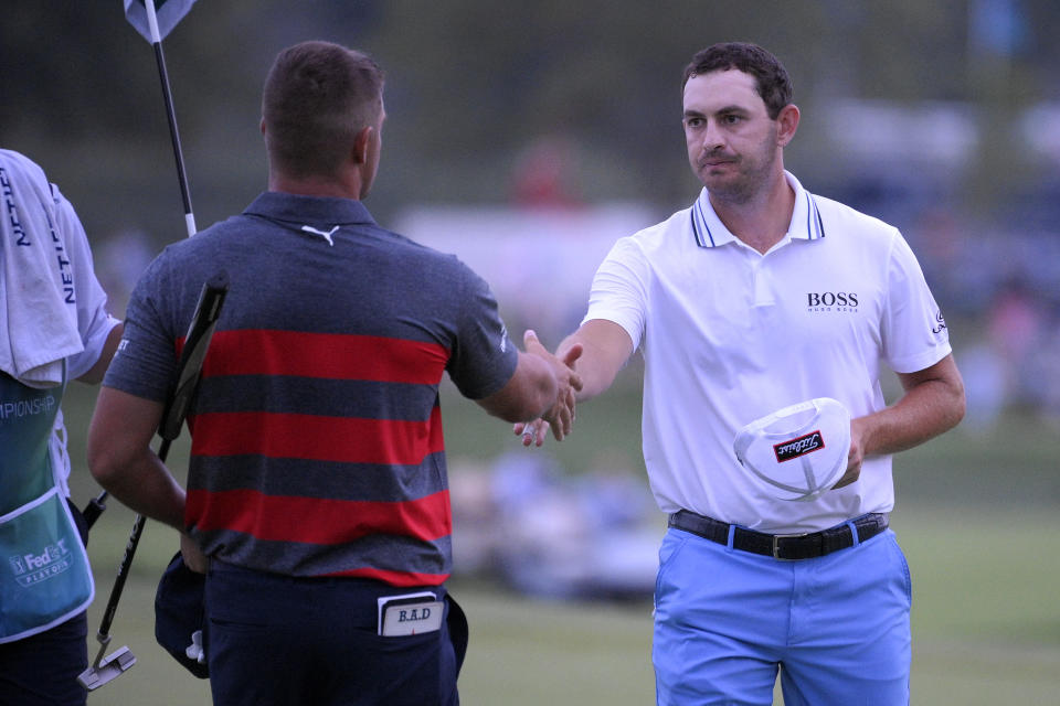 Patrick Cantlay, right, shakes hands with Bryson DeChambeau after Cantlay won their sixth playoff hole of the final round of the BMW Championship golf tournament, Sunday, Aug. 29, 2021, at Caves Valley Golf Club in Owings Mills, Md. (AP Photo/Nick Wass)