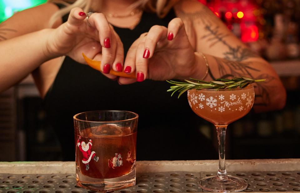 At the Miracle at Ravish holiday pop-up, a bartender adds a touch of orange to a Snowball Old Fashioned, which sits next to a Christmapolitan cocktail. Offered throughout December, the cocktails made an appearance at a Palm Beach Food and Wine Festival barbecue event at Ravish in Lantana on Dec. 9.