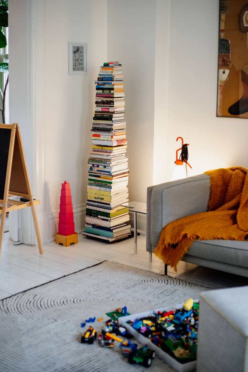 Books stacked in living room.