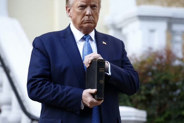President Donald Trump holds a Bible as he visits outside St John’s Church (Patrick Semansky/AP)