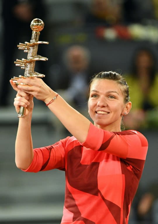 Romania's Simona Halep celebrates with the Madrid Open trophy on May 7, 2016