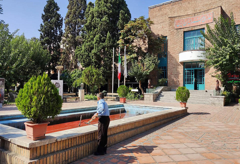 A man looking at the water, reportedly colored red in protest against a deadly crackdown on three weeks of protests sparked by the death in custody of Mahsa Amini, in a fountain outside the Artists Forum at Honarmandan Park, Tehran, on Oct. 7.<span class="copyright">AFP/Getty Images</span>