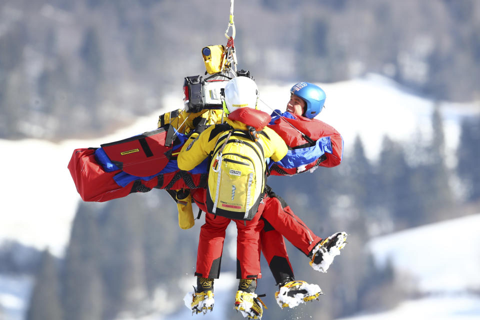 United States' Ryan Cochran Siegle is being lifted to the emergency helicopter after he crashed onto the safety net during an alpine ski, men's World Cup downhill in Kitzbühel, Austria, Friday, Jan. 22, 2021. (AP Photo/Marco Trovati)