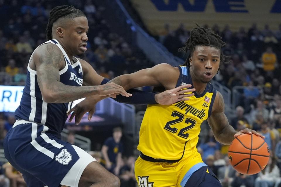 Marquette's Sean Jones tries to get past Butler's Jahmyl Telfort during the first half of an NCAA college basketball game Wednesday, Jan. 10, 2024, in Milwaukee. (AP Photo/Morry Gash)