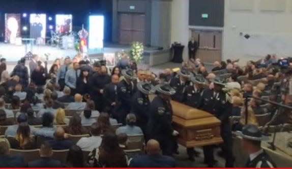 A DOC honor guard escorts Christine Guerin Sandoval's casket out of Praise Assembly of God Church on Oct. 9, 2023, as seen on a livestream of the service.