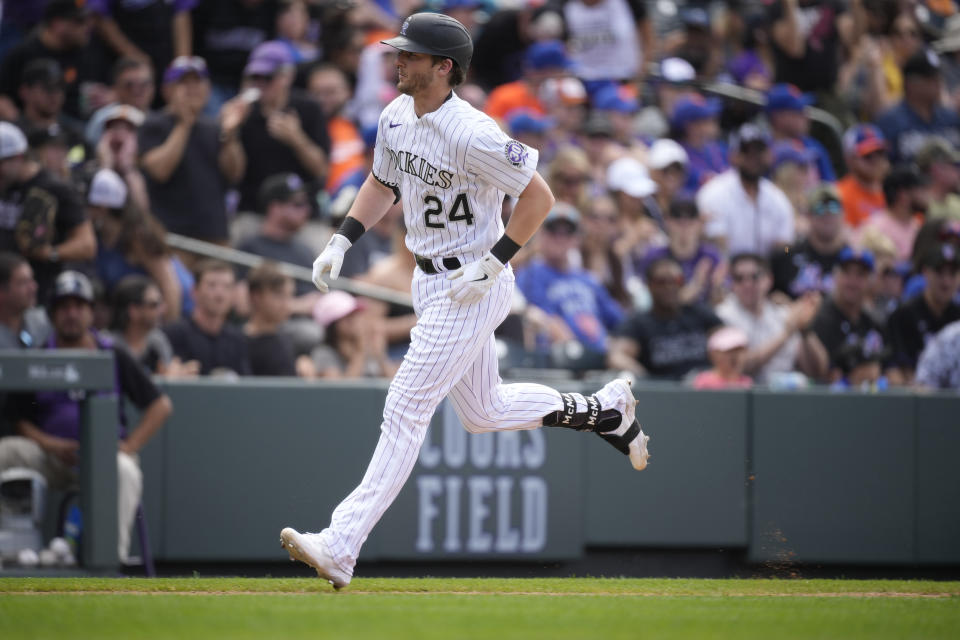 Colorado Rockies' Ryan McMahon circles the bases after hitting a two-run home run off New York Mets relief pitcher Stephen Nogosek in the fifth inning of a baseball game Sunday, May 28, 2023, in Denver. (AP Photo/David Zalubowski)