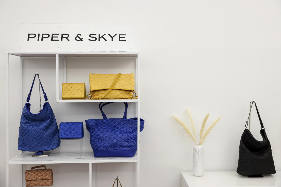 Pirarucu leather bags and purses are displayed in Piper & Skye's showroom, Tuesday, Oct. 25, 2022, in New York. In New York City, the luxury brand Piper & Skye has used pirarucu leather for shoulder bags, waist packs and purses that can fetch up to $850. (AP Photo/Julia Nikhinson)