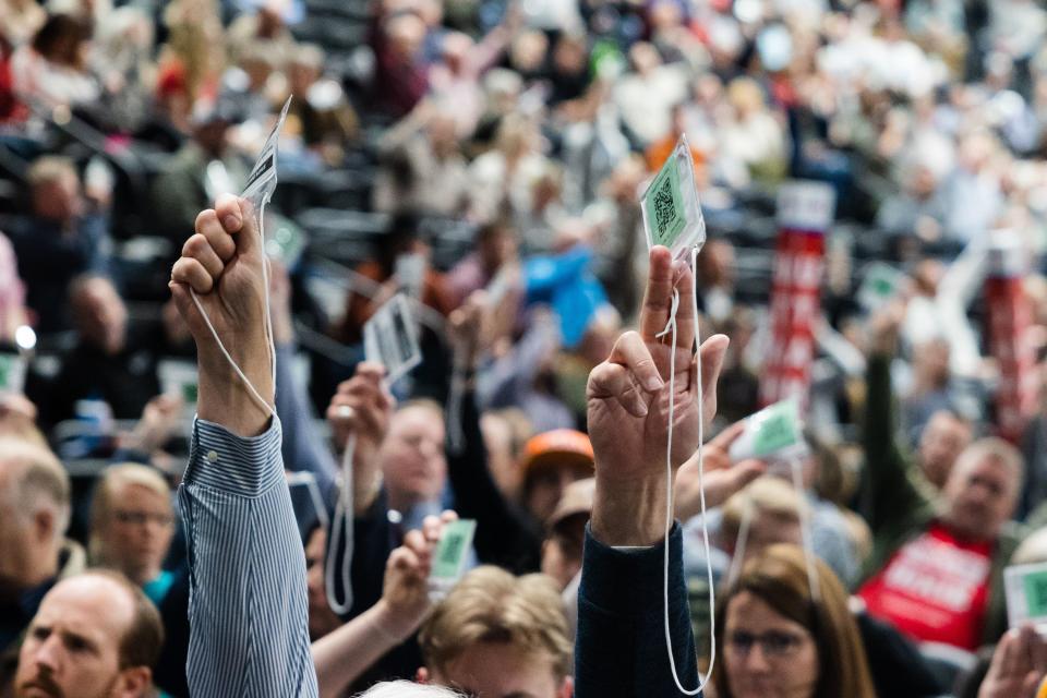 Attendees raise their credentials to vote during the Utah Republican Party Organizing Convention at Utah Valley University in Orem on Saturday, April 22, 2023. | Ryan Sun, Deseret News