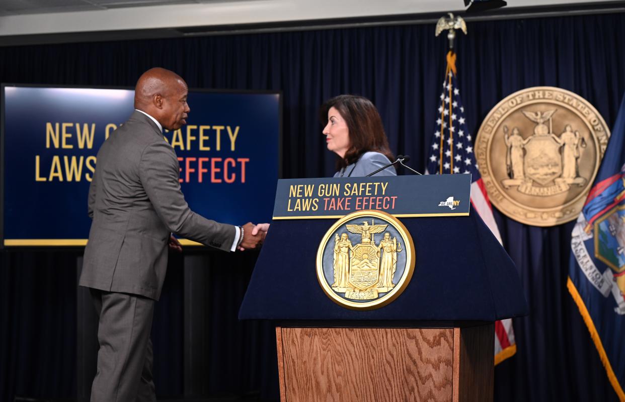 New York City Mayor Eric Adams (left) shakes hands with New York Gov. Kathy Hochul (right) in Manhattan, New York, on Wednesday, Aug. 31, 2022, during the announcement of new public safety actions ahead of new gun laws going into effect in New York state.