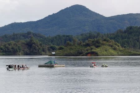 Boats are seen near a dock on the Penol-Guatape reservoir as the search for people believed to be missing after a tourist boat sank on Sunday continues, in Guatape, Colombia June 26, 2017. REUTERS/Fredy Builes