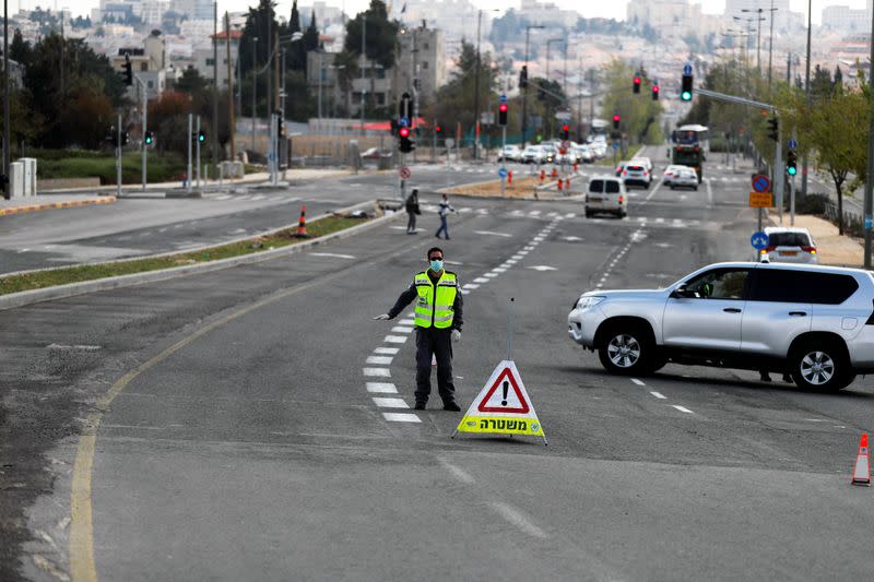 Israeli police set a roadblock on a way in Jerusalem as they try to contain the spread of the coronavirus disease (COVID-19) from the densely populated neighborhoods where the infection rate is high