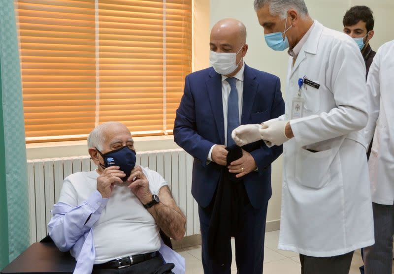 Jordanian Doctor Dawoud Hananiah, prepares to receive the first COVID-19 vaccine in Jordan, at a medical center in Amman