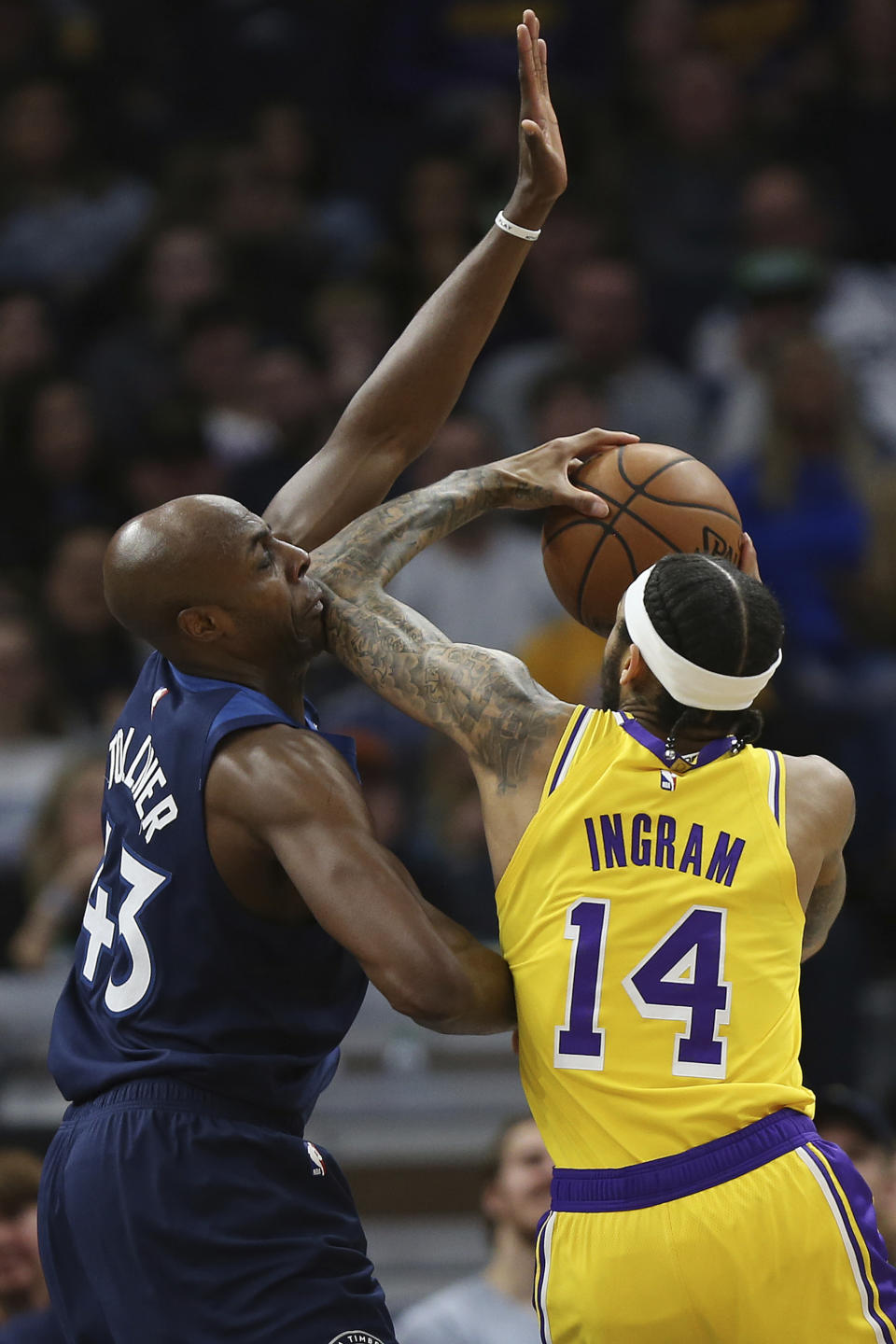 Los Angeles Lakers' Brandon Ingram bumps Minnesota Timberwolves' Anthony Tolliver in the face while trying to get to the basket in the first half of an NBA basketball game Sunday, Jan. 6, 2019, in Minneapolis. (AP Photo/Stacy Bengs)