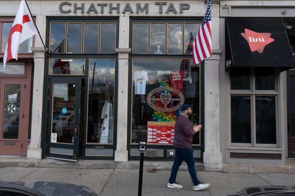 A soccer fan leaves Chatham Tap, a bar in the Chatham Arch neighborhood of Indianapolis, Tuesday, Nov. 29, 2022, after Team USA’s men’s victory over Iran in the opening round of the World Cup. 