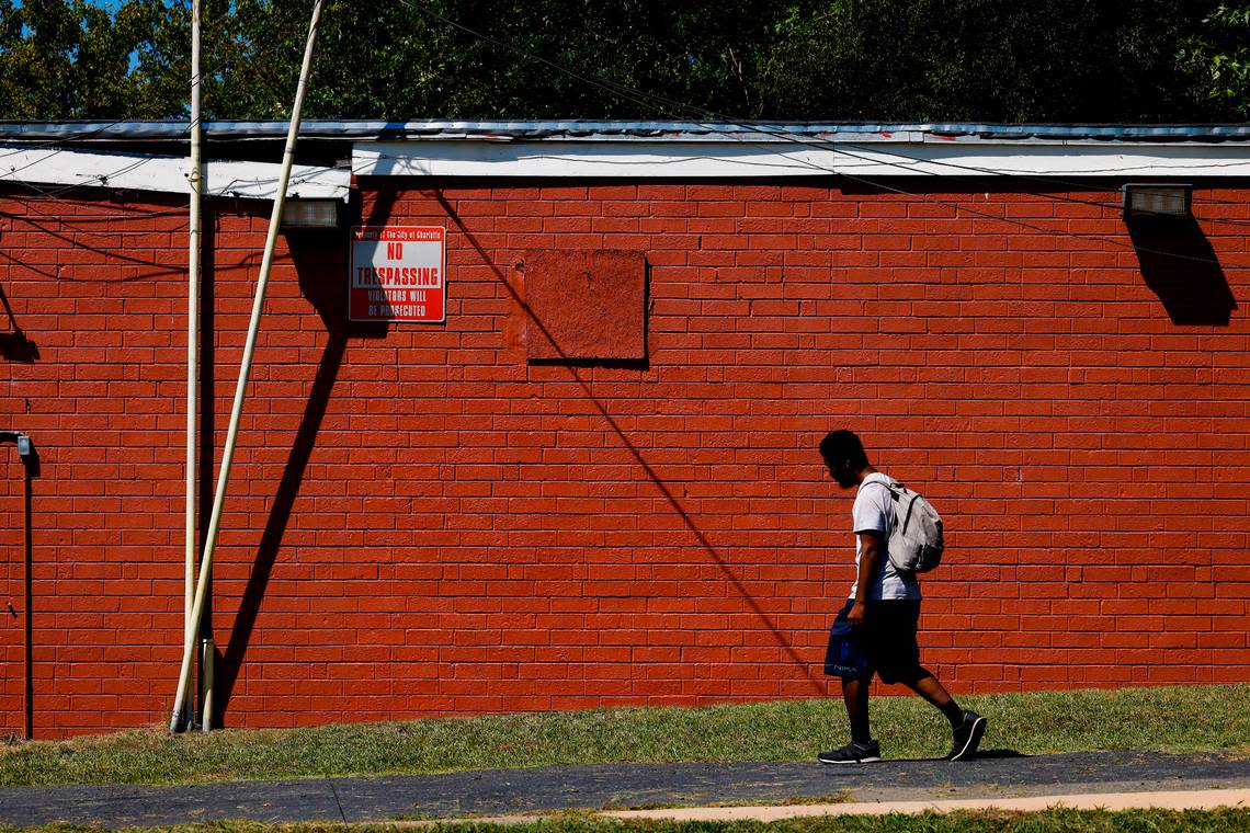 Johnny Alston, of Durham, walks past a mural from artist Kyle Holbrook which was recently covered by the building owner of Parkwood Food Mart who says the mural was applied without permission, in Charlotte, N.C., Thursday, Sept. 1, 2022.