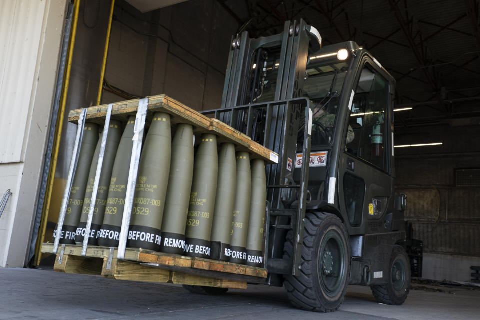FILE - Airmen with the 436th Aerial Port Squadron use a forklift to move 155 mm shells ultimately bound for Ukraine, April 29, 2022, at Dover Air Force Base, Del. For almost 20 months the Pentagon has spearheaded a monthly gathering of about 50 allies where the U.S. has led the way in sending billions of dollars in aid to Kyiv. But on Jan. 23, 2024, for the first time since Secretary of Defense Lloyd Austin established the group in April of 2022, the U.S. will come to the table out of money, unable to send Ukraine the ammunition and missiles it needs to fend off Russia. (AP Photo/Alex Brandon, File)