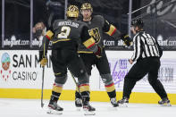 Vegas Golden Knights defenseman Zach Whitecloud (2) celebrates after center Nicolas Roy, right, scored against the St. Louis Blues during the third period of an NHL hockey game Friday, May 7, 2021, in Las Vegas. (AP Photo/John Locher)