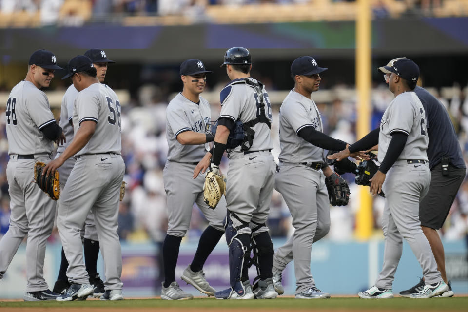 The New York Yankees celebrate a 4-1 win over the Los Angeles Dodgers after their baseball game in Los Angeles, Sunday, June 4, 2023. (AP Photo/Ashley Landis)