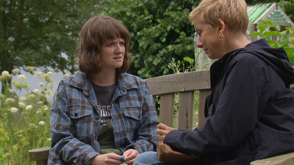  Gail looks confused while sitting on a bench in Emmerdale  