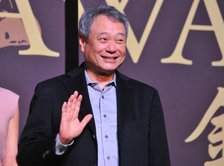 Oscar-winning director Ang Lee waves during a media event for the 50th Golden Horse awards in Taipei on November 12, 2013