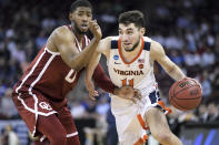 FILE - In this March 24, 2019, file photo, Virginia guard Ty Jerome (11) dribbles the ball as Oklahoma guard Christian James defends during the second half of a second-round game in the NCAA men's college basketball tournament in Columbia, S.C. Jerome could go in the first round of Thursday's NBA draft and play either guard position. (AP Photo/Sean Rayford, File)