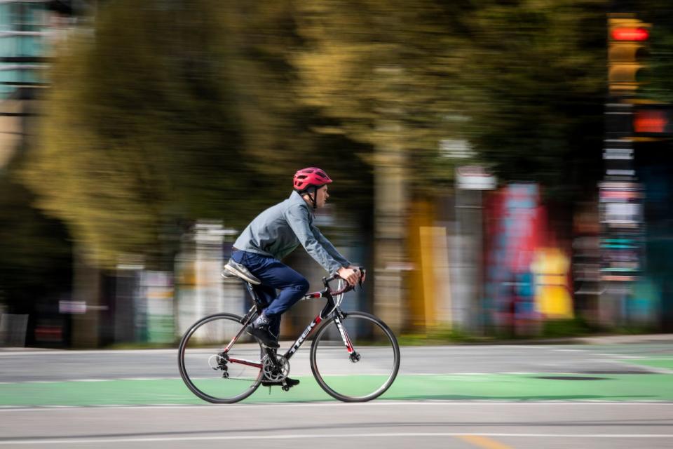 A cyclist cruises through downtown Vancouver in April 2021. In the past three years, demand for bikes has skyrocketed and, this spring, shop owners say they finally have the supply they need to serve that pent up demand this spring.