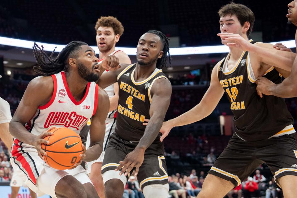 Nov 19, 2023; Columbus, Ohio, USA;
Ohio State Buckeyes guard Evan Mahaffey (12) looks for a shot through Western Michigan Broncos defenders during their game on Sunday, Nov. 19, 2023 at the Value City Arena.