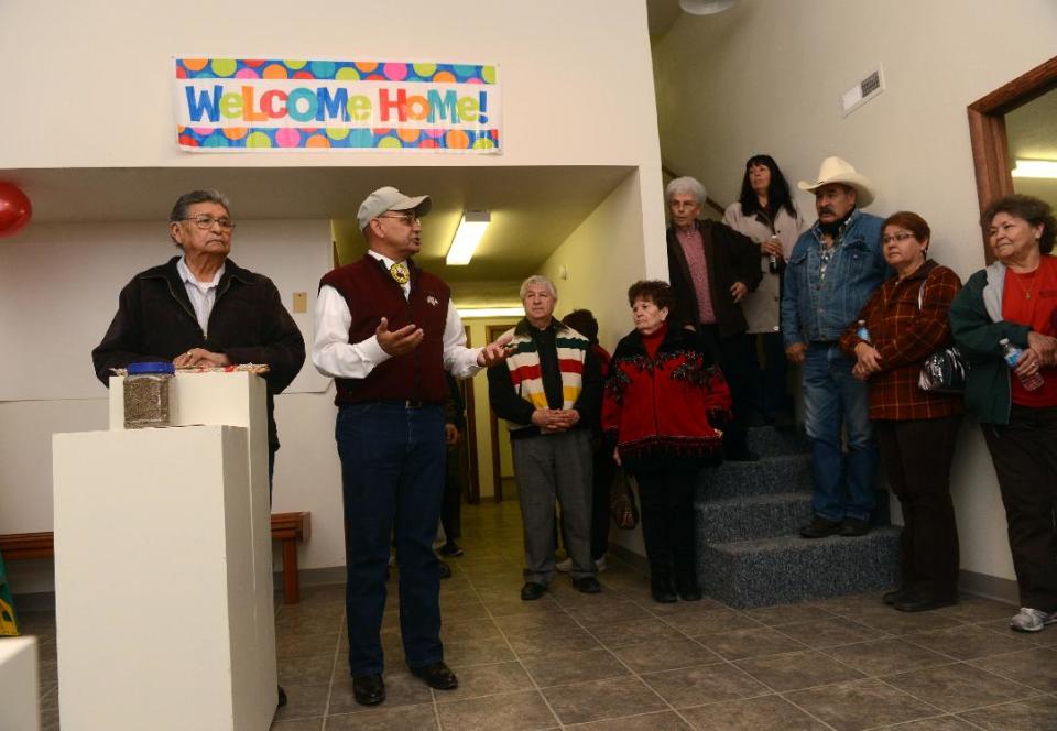 FILE - In this Saturday, Nov. 3, 2012 file photo, Henry Anderson, left, and James Parker Shield welcome people to the new Little Shell Chippewa Cree Visitor Center in Montana. Montana's Little Shell tribe appeared poised to fade from history in recent years after it was denied federal government recognition, lost its financial support from the state and saw its elected leadership splinter. But the past year has brought a sharp turnaround for the 4,500-member landless tribe that long has existed on society's fringe. Tribal enrollment is on the rise. Government grant money is flowing again, and the Little Shell cultural and visitor center opened this month in Great Falls. (AP Photo/The Great Falls Tribune, Rion Sanders) NO SALES