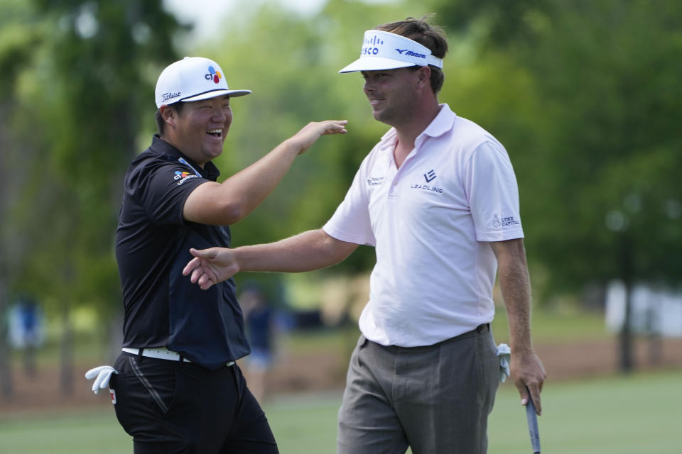 Sungjae Im, of South Korea, left, reacts with his partner Keith Mitchell after Mitchell made a birdie putt on the seventh hole during the first round of the PGA Zurich Classic golf tournament at TPC Louisiana in Avondale, La., Thursday, April 20, 2023. (AP Photo/Gerald Herbert)